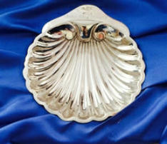 An image of the John King Trophy, an engraved silver baptismal scalop shell